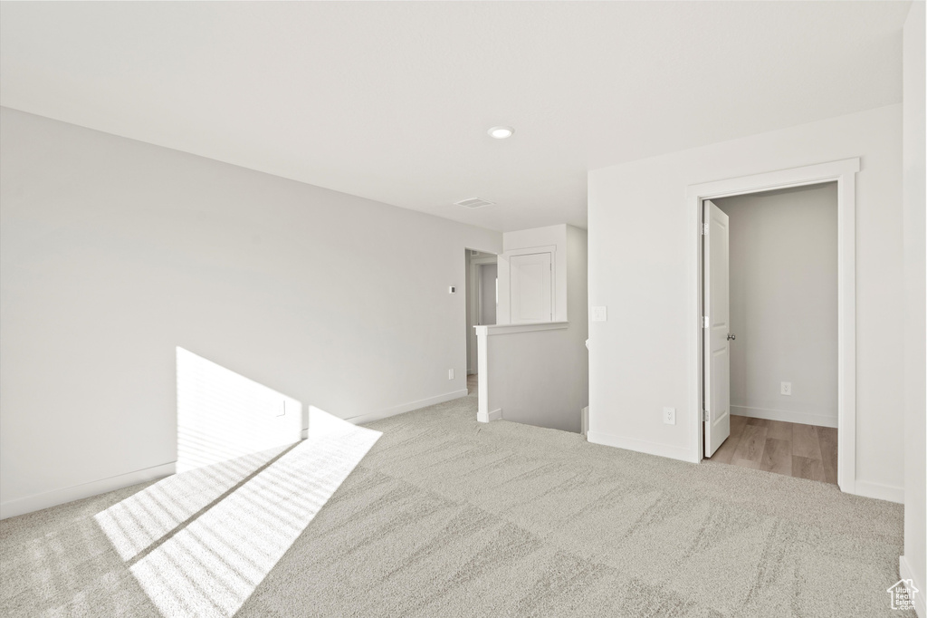 Unfurnished room featuring light colored carpet and recessed lighting