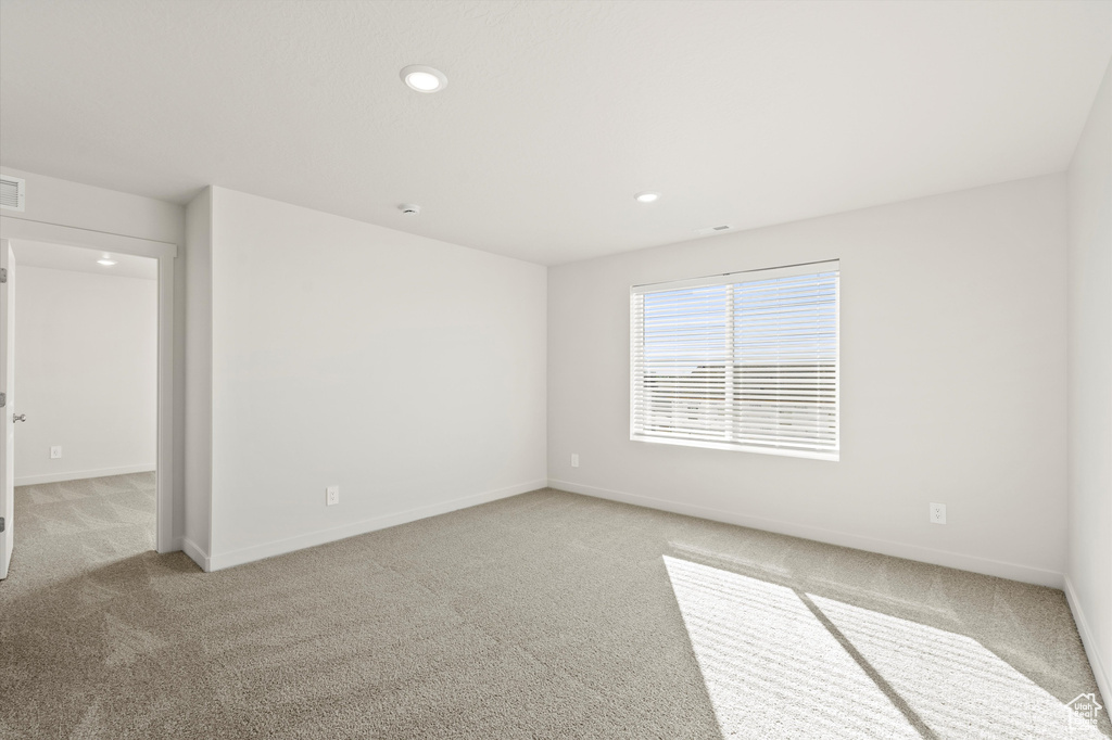 Spare room with light carpet and recessed lighting