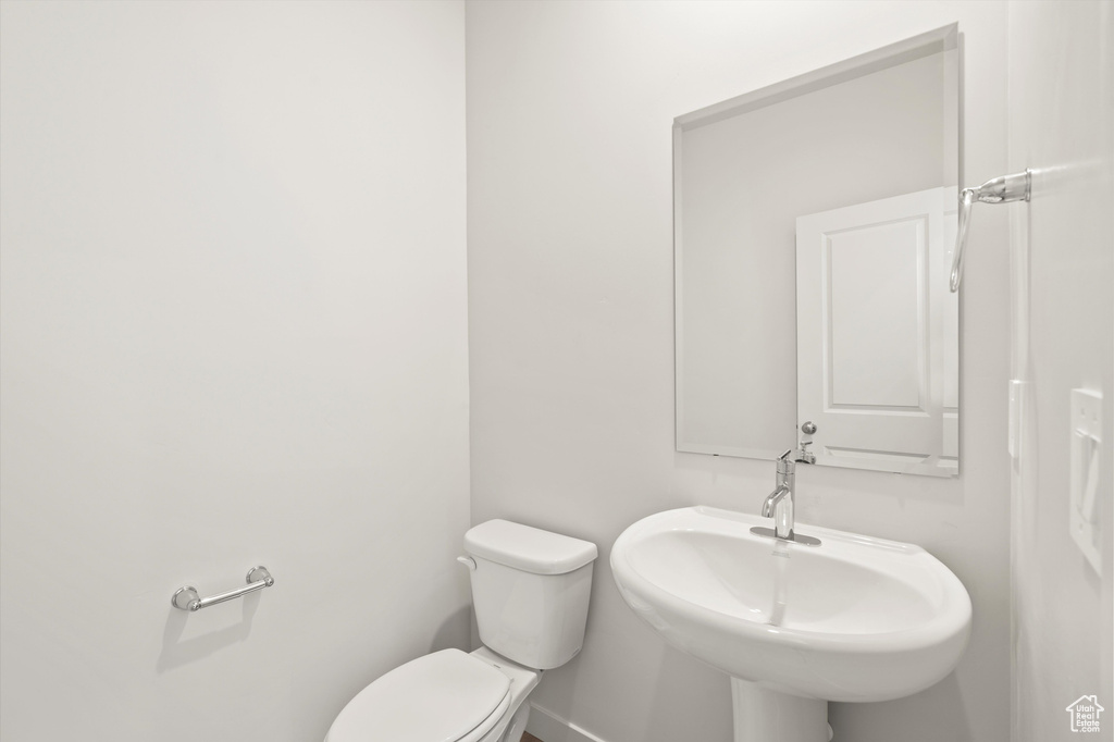 Half bathroom with toilet and a sink