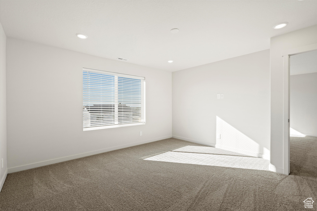 Empty room featuring carpet flooring and recessed lighting