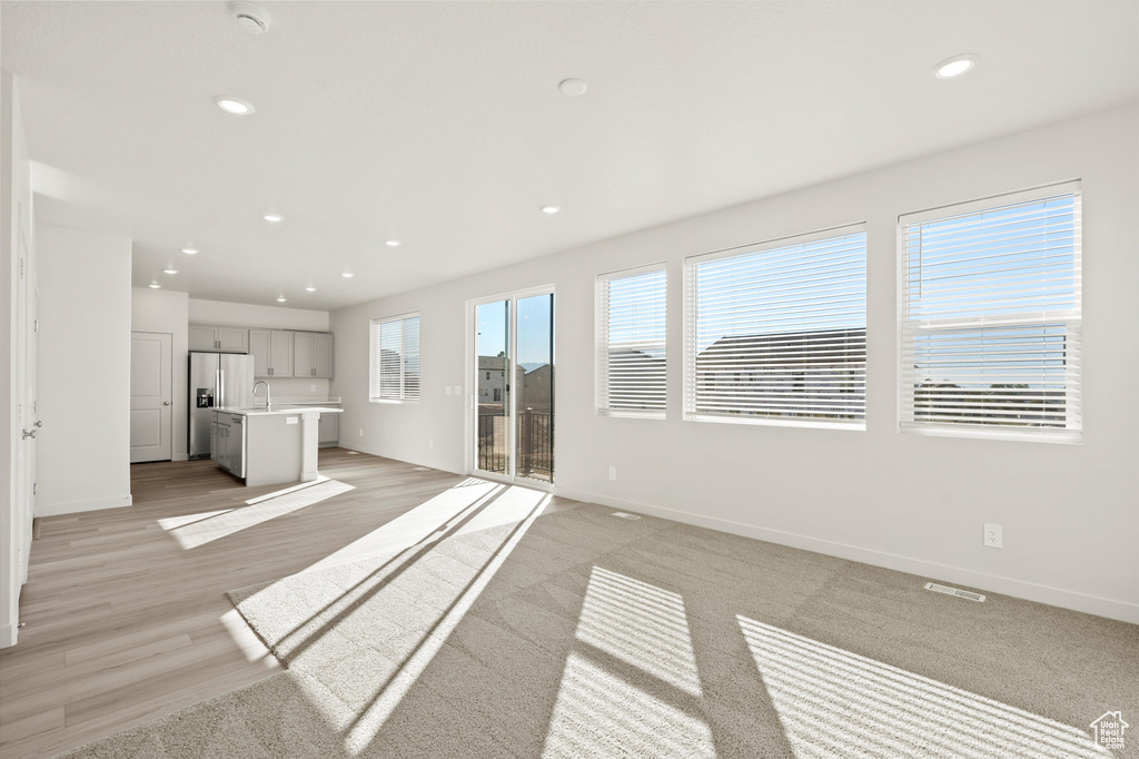 Unfurnished living room featuring recessed lighting