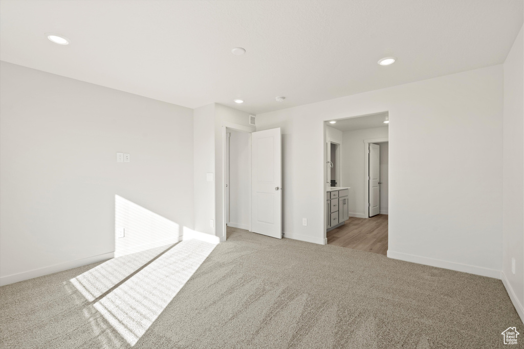 Unfurnished room with light carpet and recessed lighting