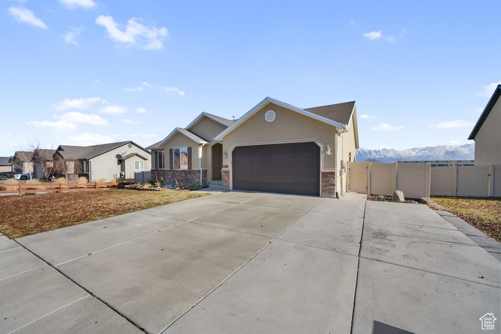 Single story home with a mountain view and a garage