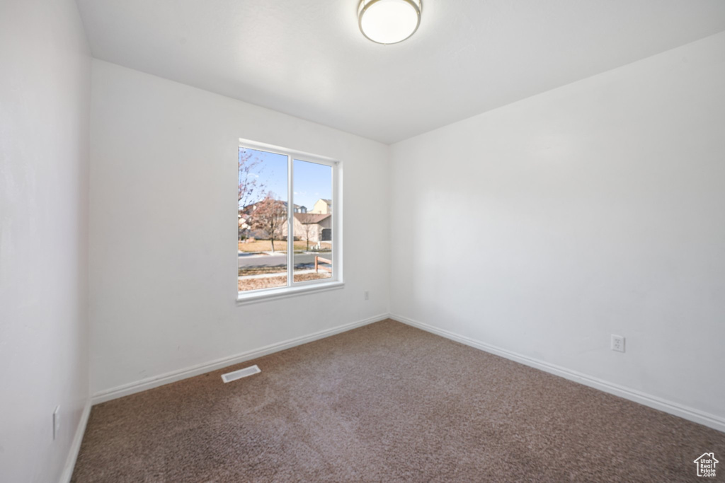 Unfurnished room with carpet floors