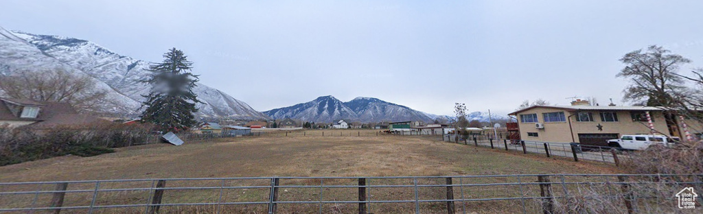 View of yard with a mountain view, a rural view, and a garage