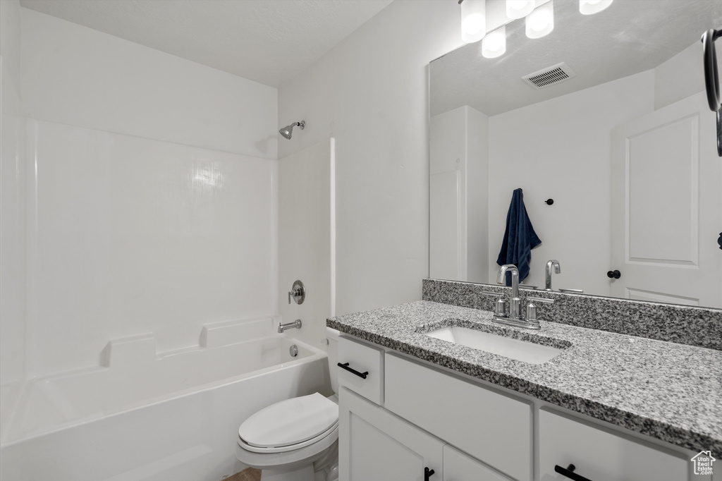 Full bathroom featuring shower / washtub combination, vanity, and toilet