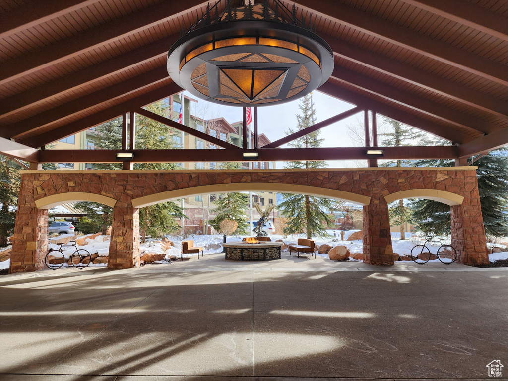 View of home's community with an outdoor fire pit and a patio area
