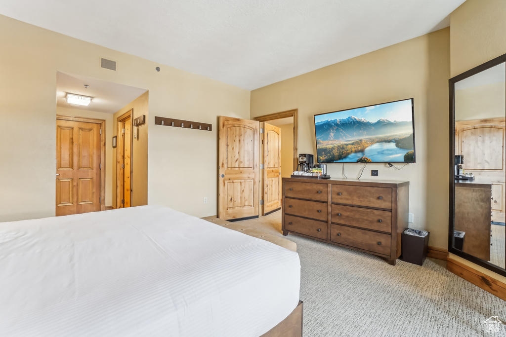 Bedroom with light carpet