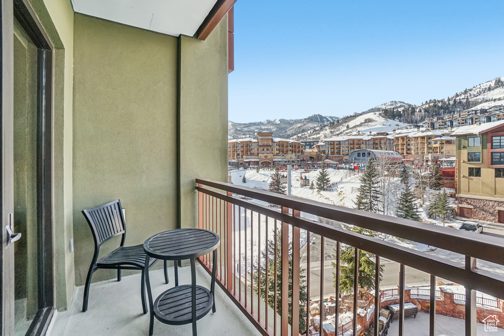 Snow covered back of property featuring a mountain view