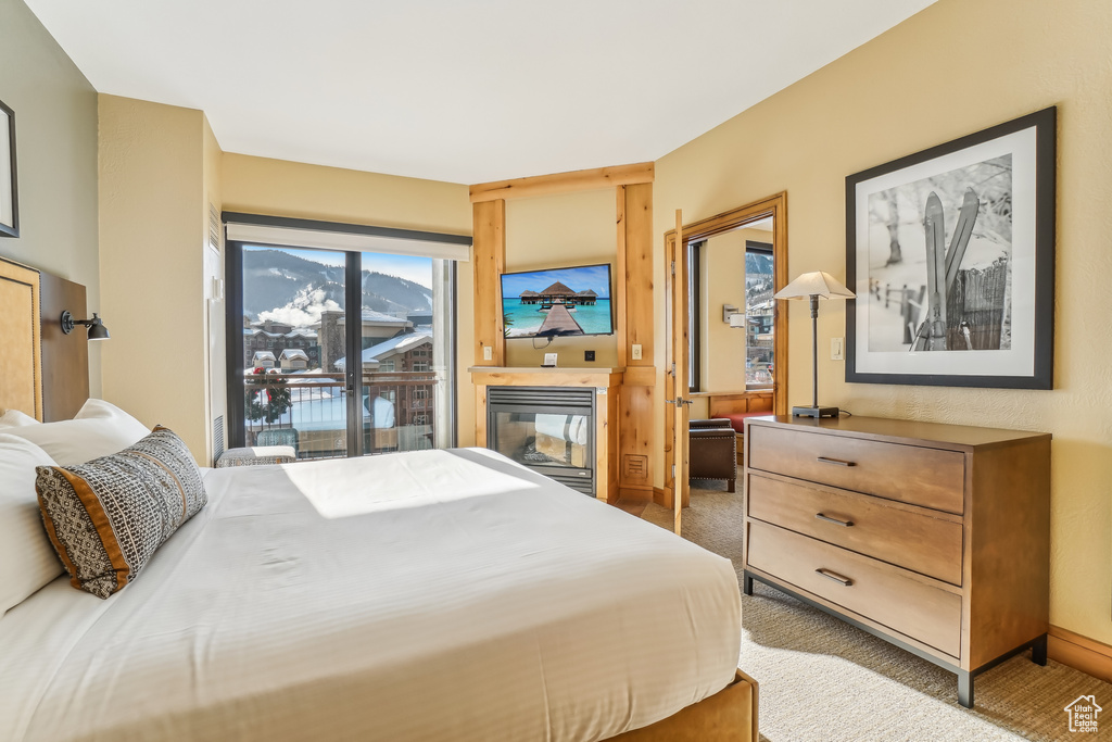 Bedroom with carpet floors and access to outside