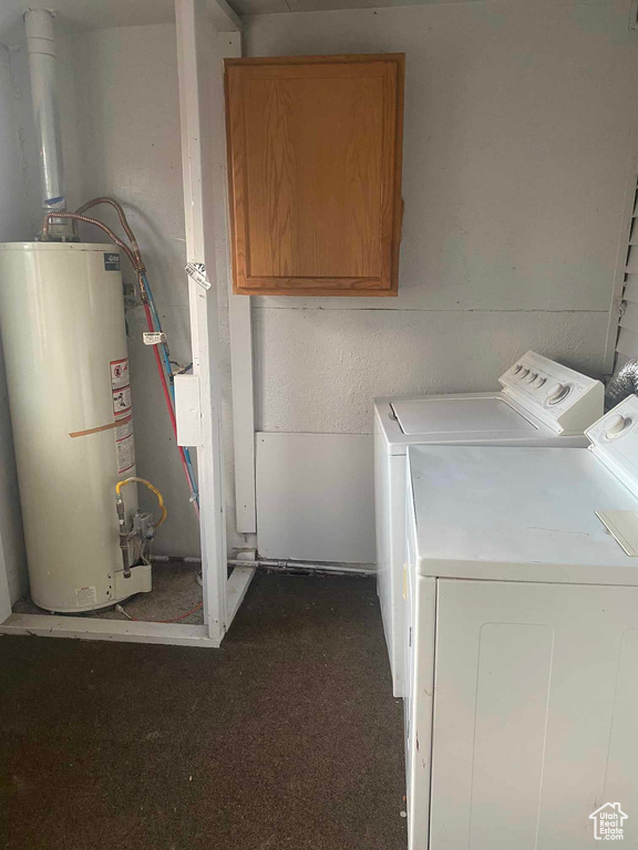 Laundry area with water heater, washer and clothes dryer, and cabinets