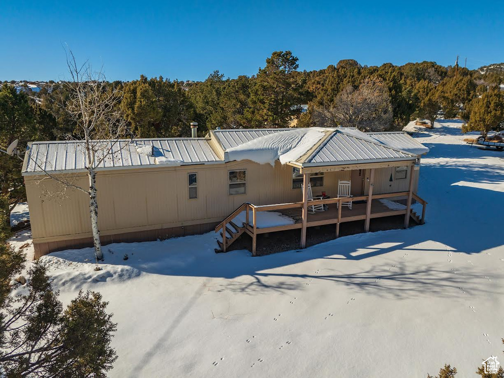 Snow covered property featuring a deck