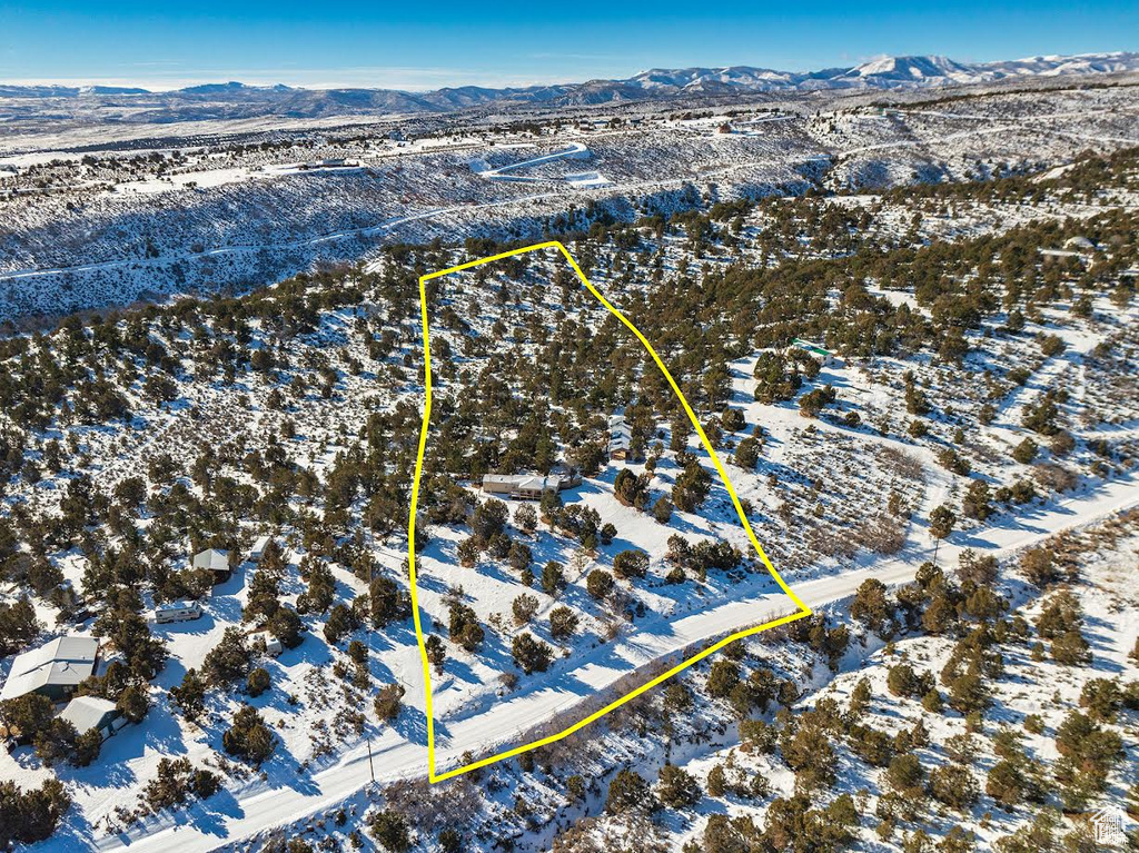 Snowy aerial view featuring a mountain view