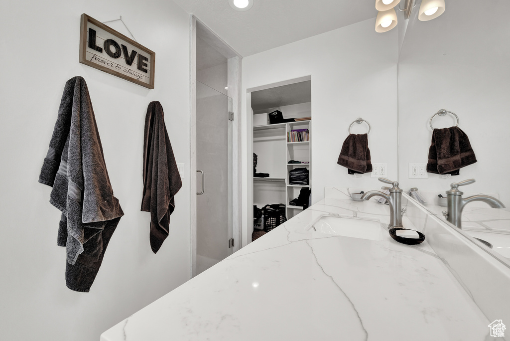 Bathroom featuring vanity and an enclosed shower