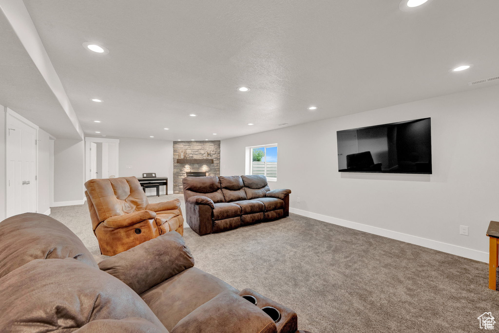 Living room featuring a fireplace and light carpet