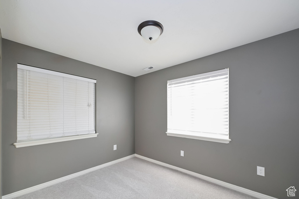Unfurnished room featuring baseboards and carpet floors