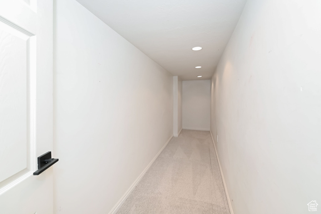 Hall with light carpet, recessed lighting, and baseboards