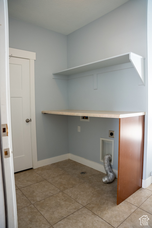 Clothes washing area with hookup for an electric dryer and light tile patterned flooring