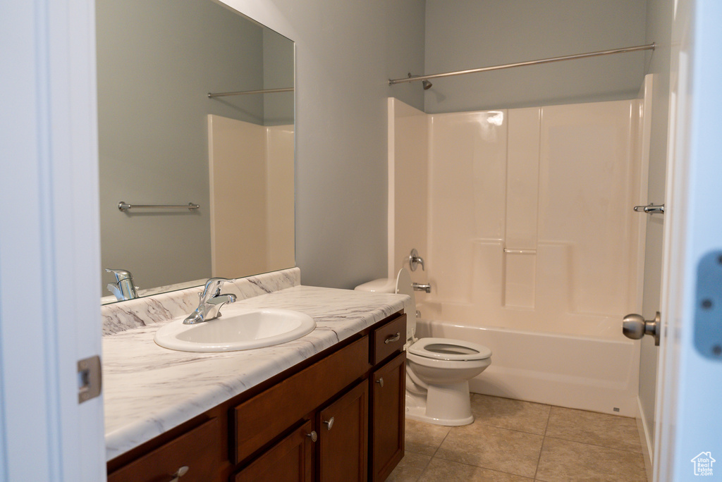 Full bathroom featuring tile patterned flooring, vanity, toilet, and shower / washtub combination