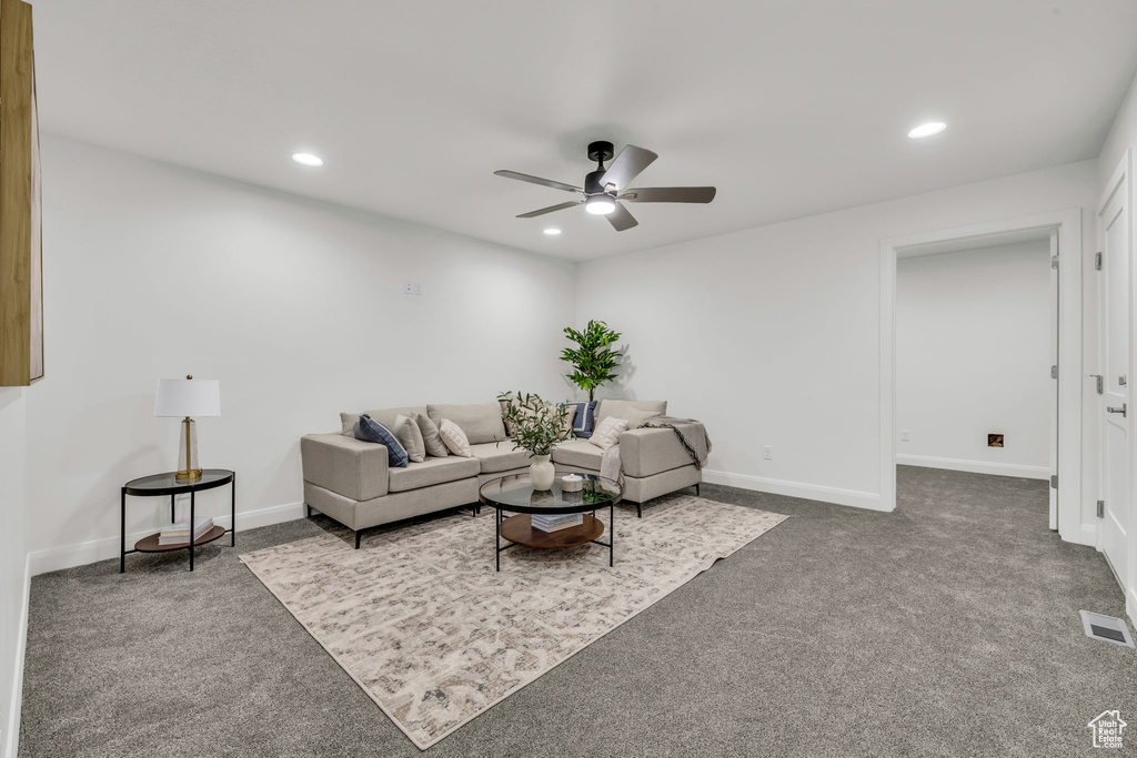 Carpeted living area featuring recessed lighting, visible vents, and baseboards