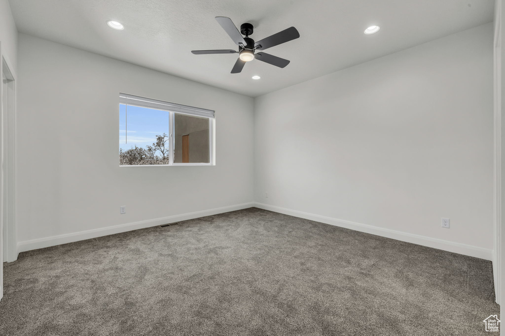 Empty room featuring baseboards, carpet, and recessed lighting