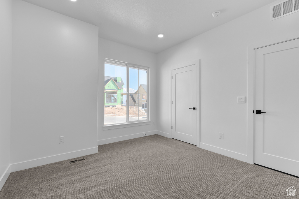 Spare room featuring light colored carpet