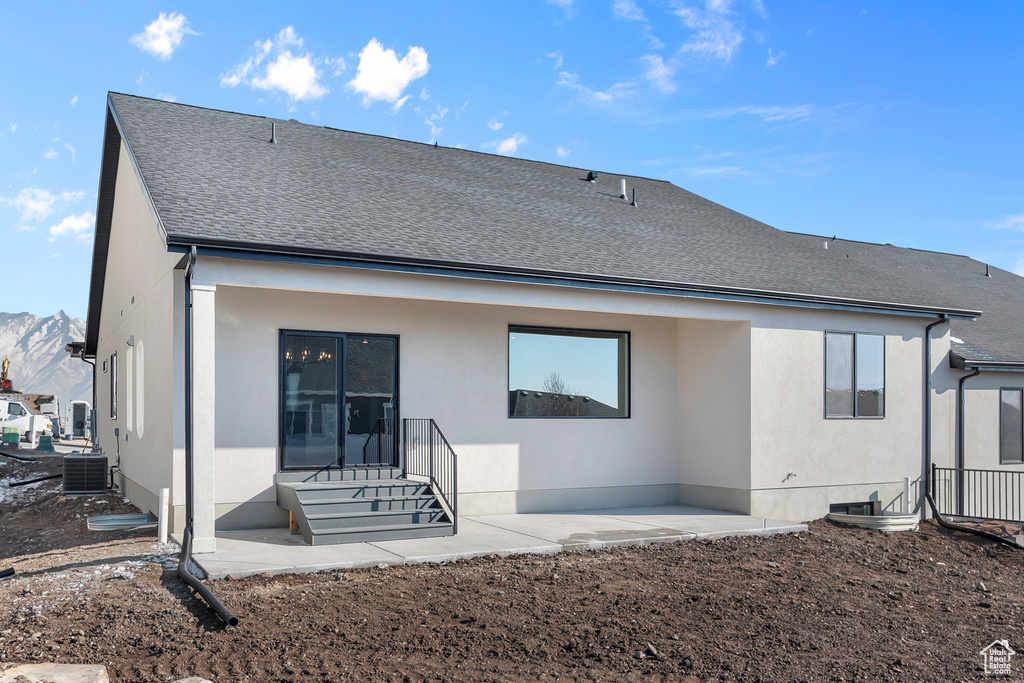 Back of house with a patio area, central AC unit, and a mountain view