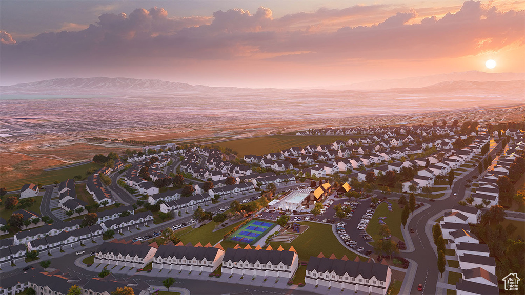 Aerial view at dusk featuring a water and mountain view