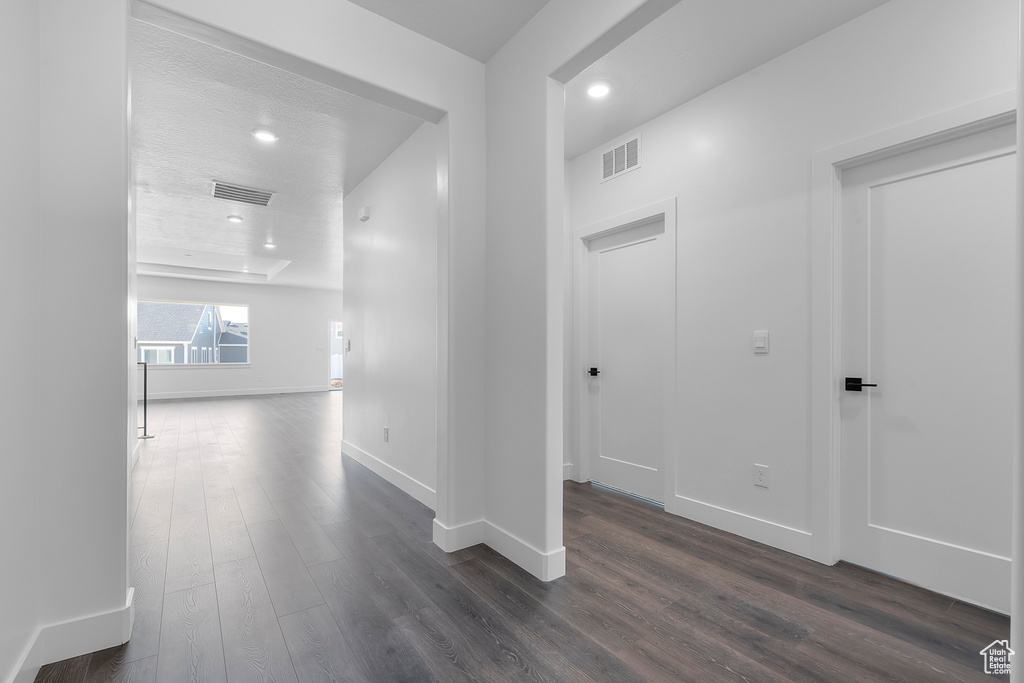 Hallway with dark hardwood / wood-style flooring