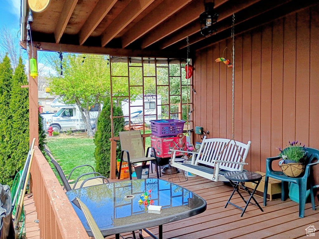 Wooden deck with fence and outdoor dining space