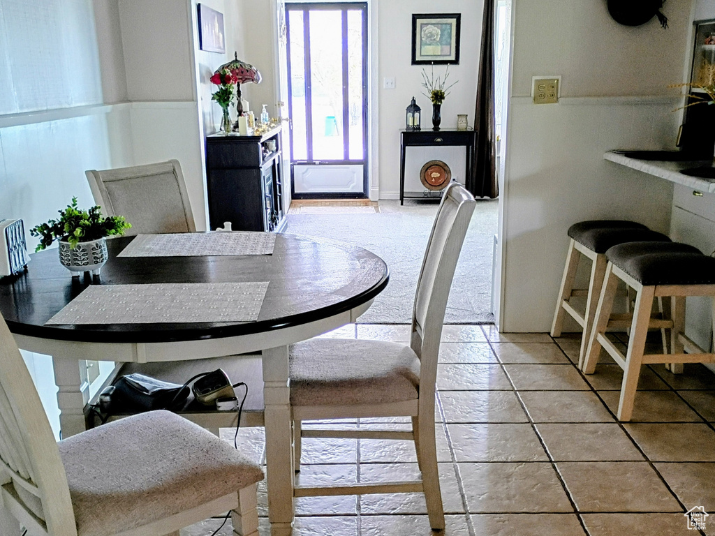 Dining room with tile patterned flooring and visible vents