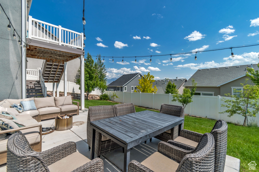 View of patio featuring stairway, outdoor lounge area, outdoor dining area, a deck, and a residential view
