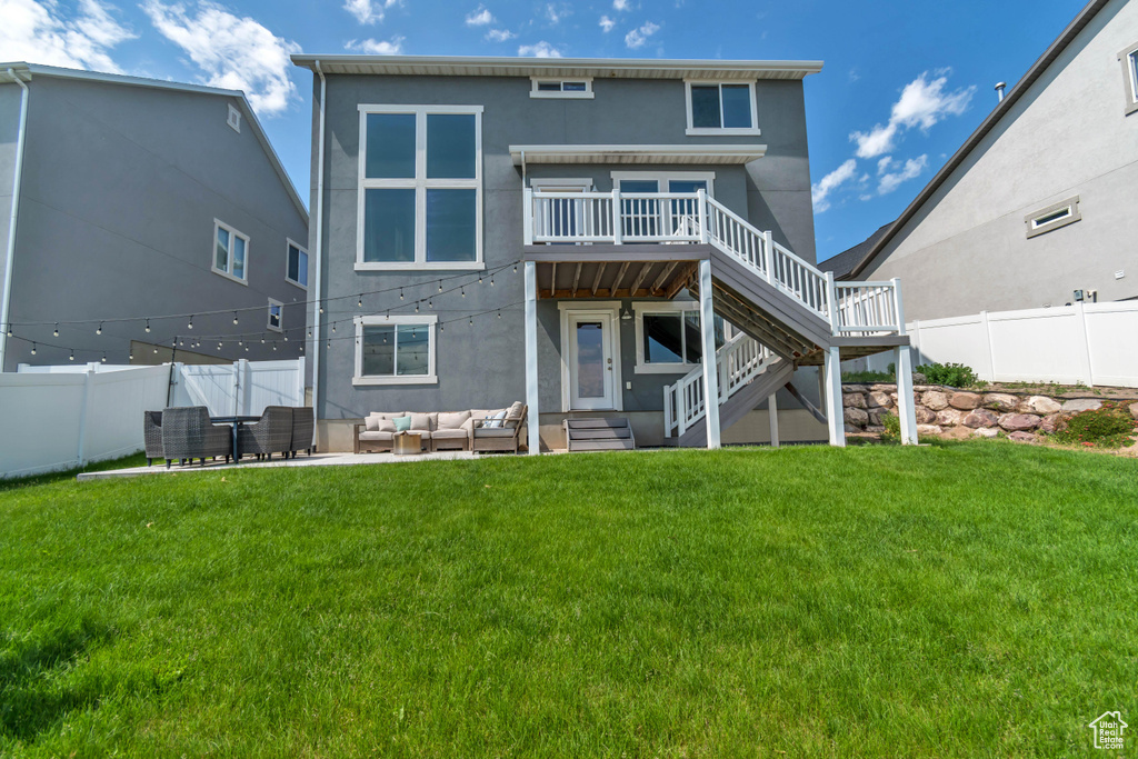 Rear view of property featuring an outdoor hangout area, a deck, stucco siding, and stairway