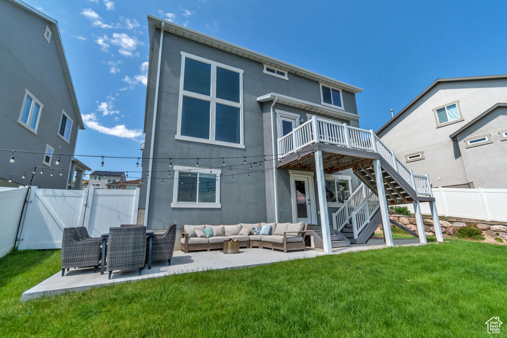 Back of house with an outdoor hangout area, stucco siding, a deck, and stairs