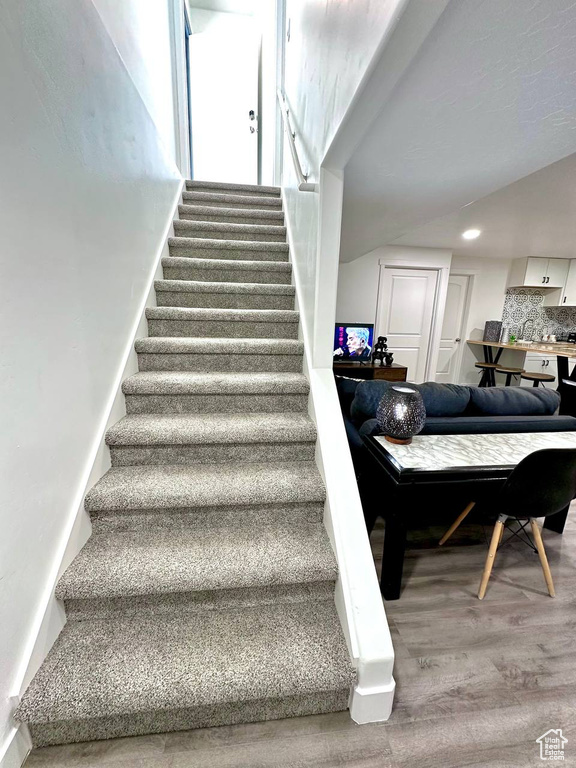 Stairs featuring wood-type flooring