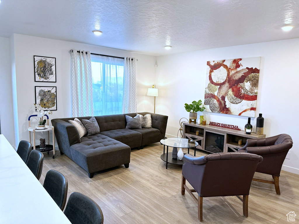 Living room featuring a textured ceiling and hardwood / wood-style flooring