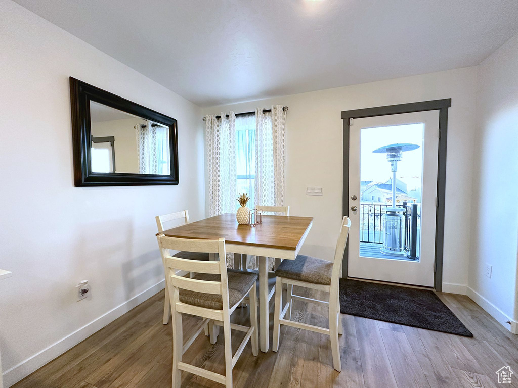 Dining space with wood-type flooring