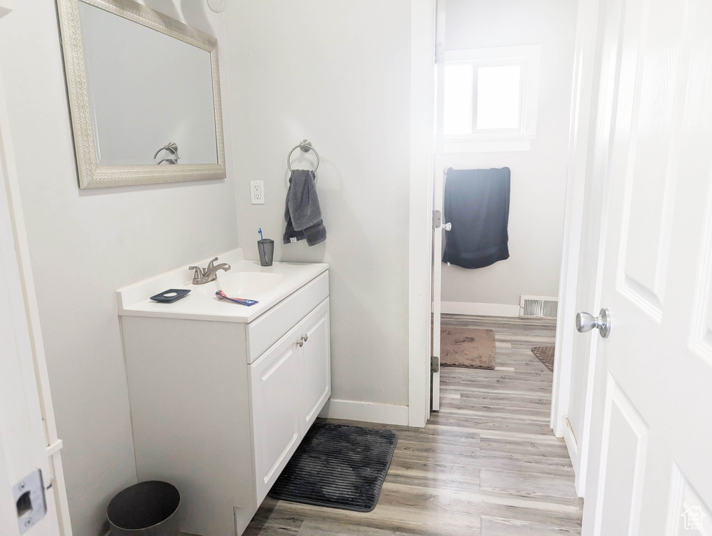 Bathroom featuring hardwood / wood-style floors and vanity
