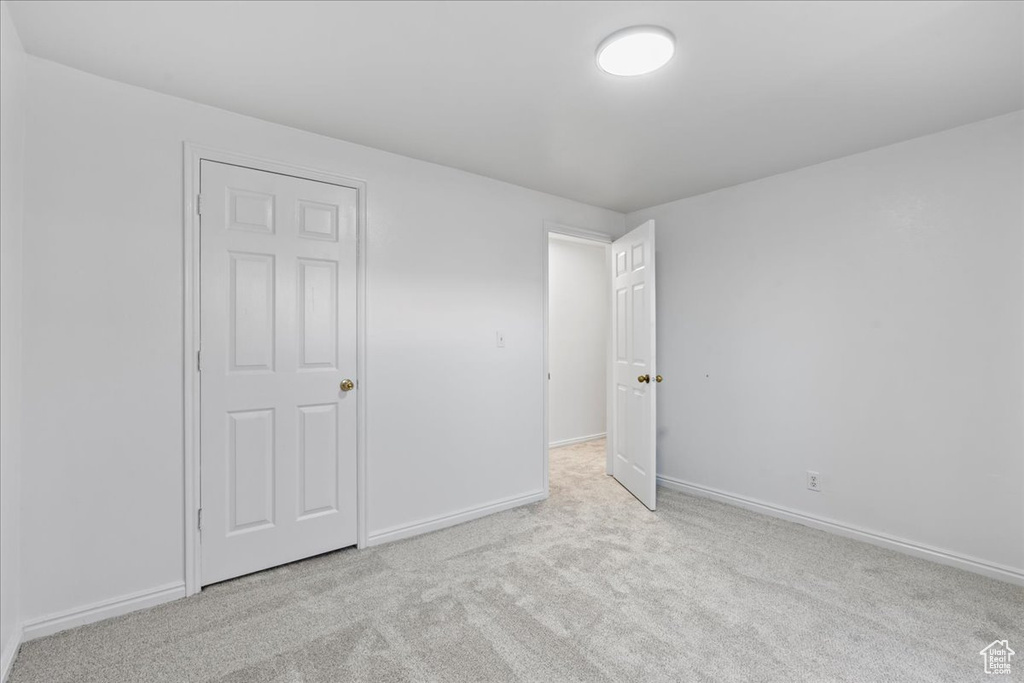 Unfurnished bedroom featuring light carpet