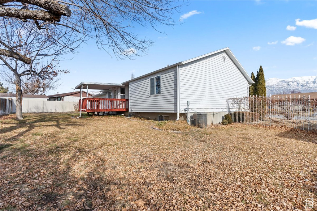 View of property exterior with a deck with mountain view and central AC unit