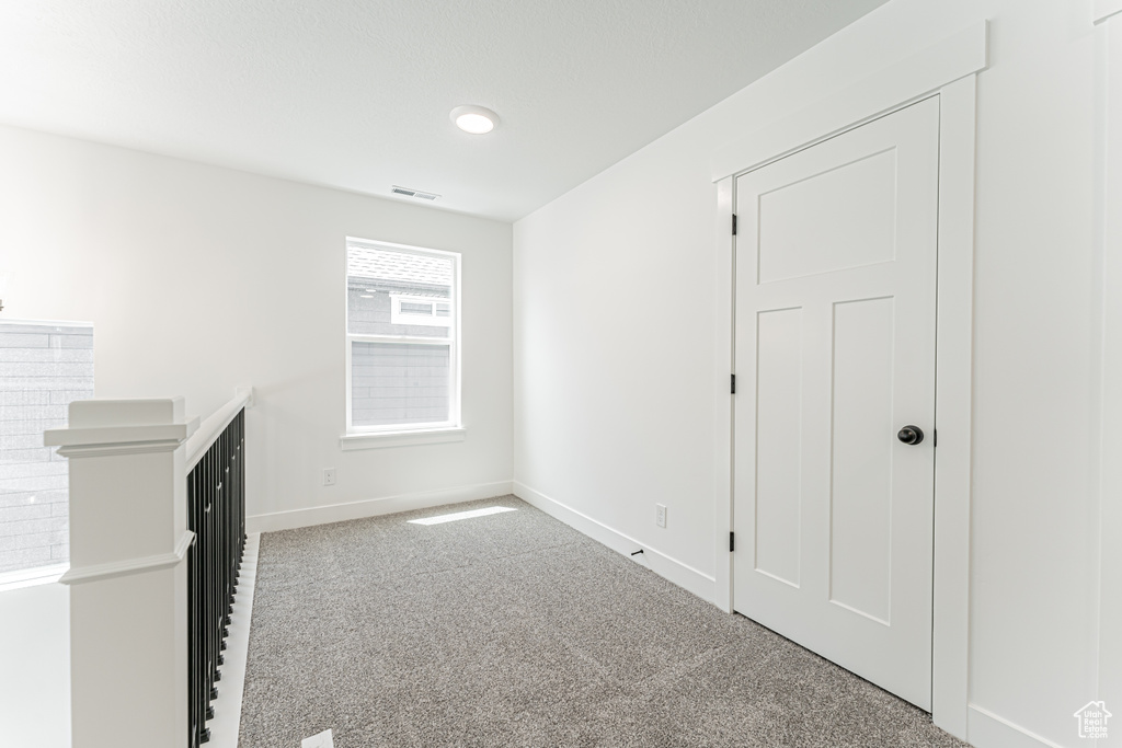 Carpeted spare room with baseboards