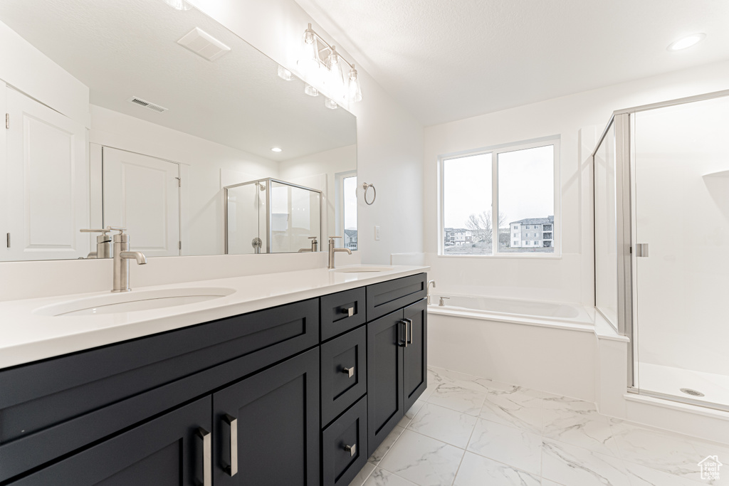 Bathroom with visible vents, a shower stall, double vanity, marble finish floor, and a sink