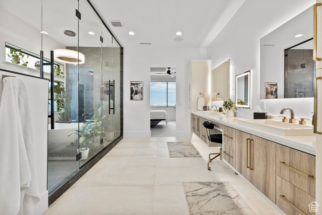 Bathroom featuring walk in shower, vanity, and ceiling fan
