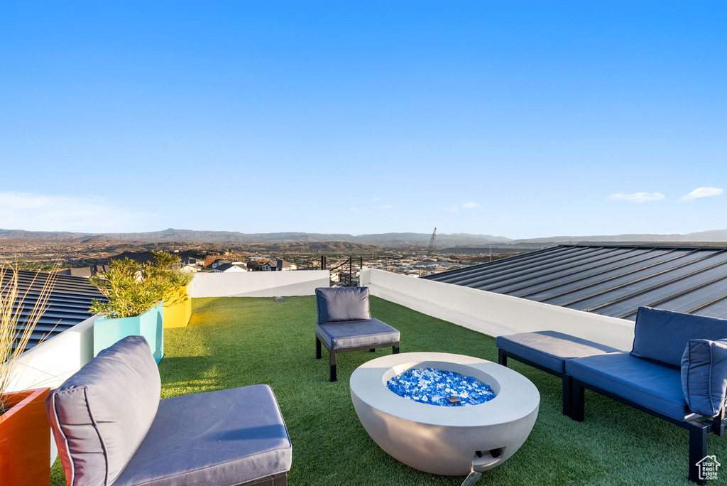 View of patio / terrace with a mountain view and a fire pit