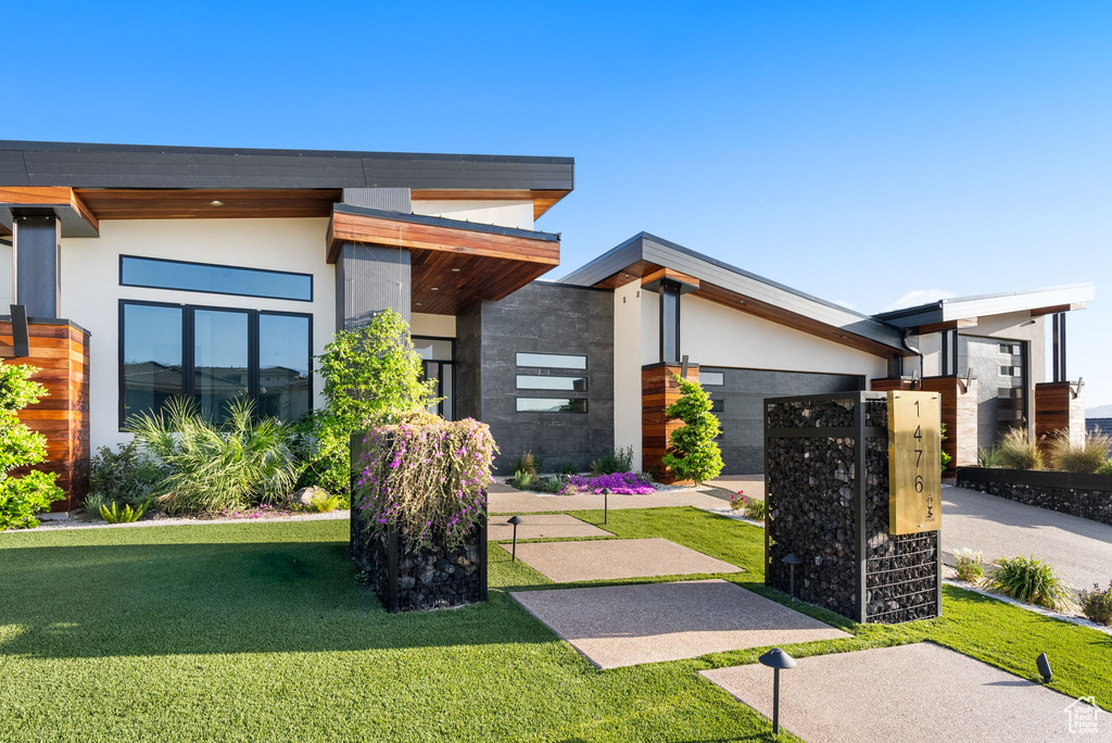 Contemporary home featuring a front lawn
