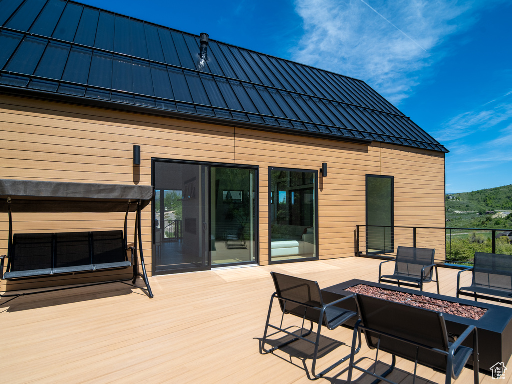 Wooden deck featuring a fire pit and a mountain view