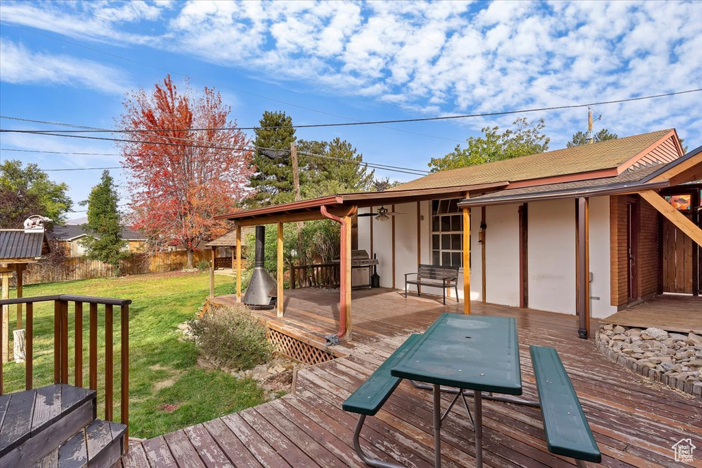 Wooden deck with a lawn and a grill
