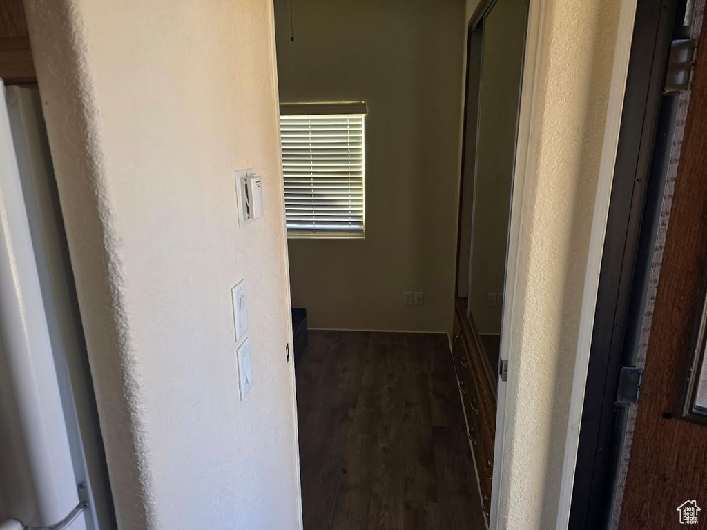 Hallway featuring dark wood-type flooring