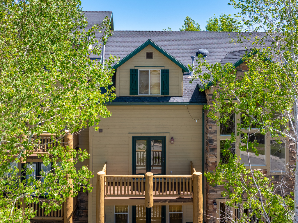 Back of property featuring a deck and french doors