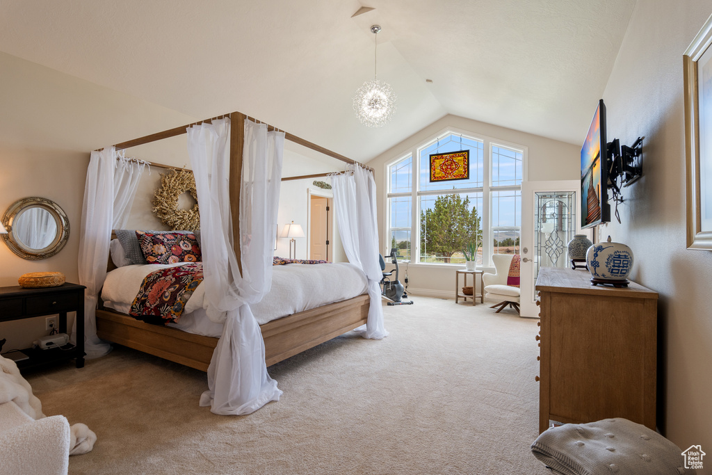 Bedroom with vaulted ceiling and carpet floors